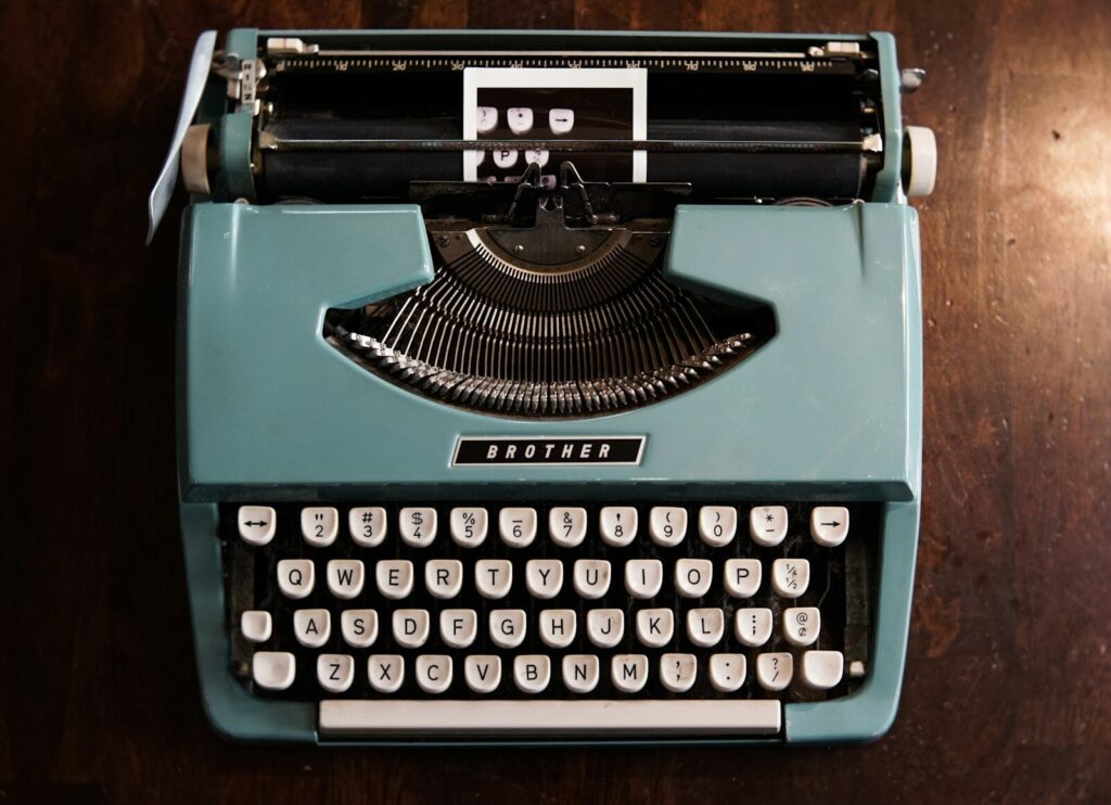 green and black typewriter on green table