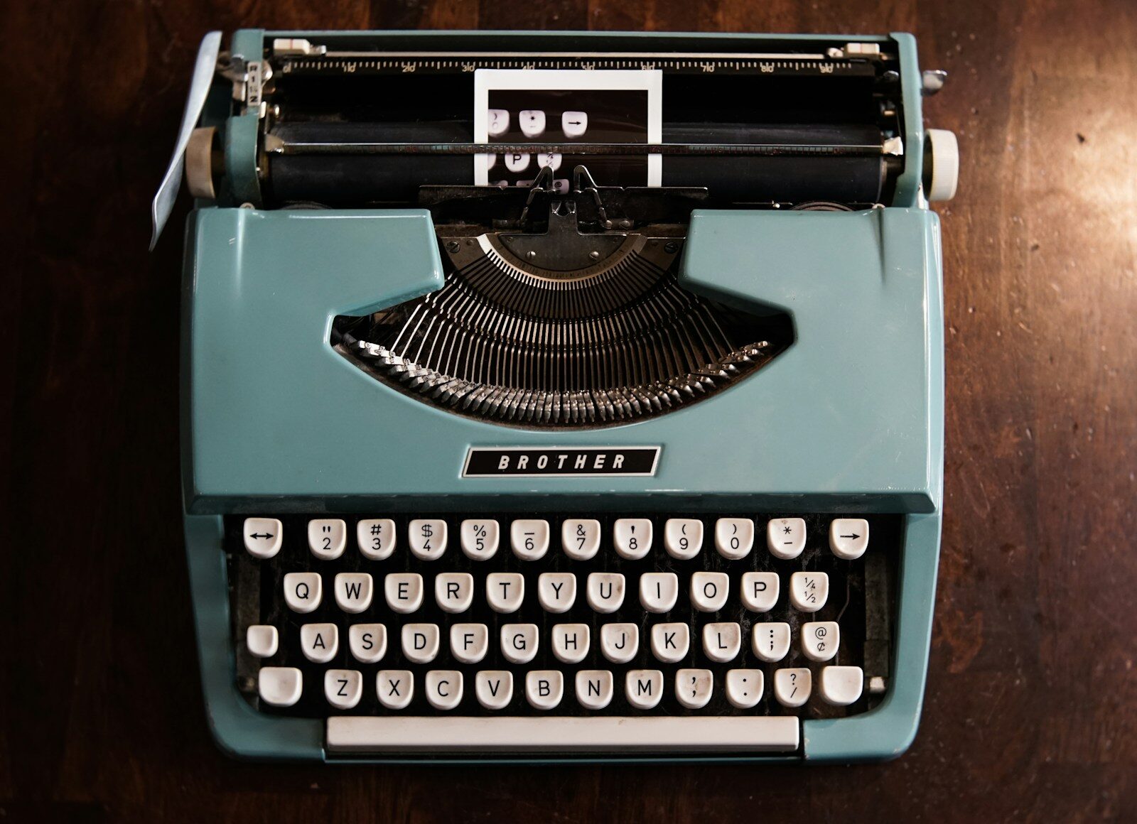 green and black typewriter on green table